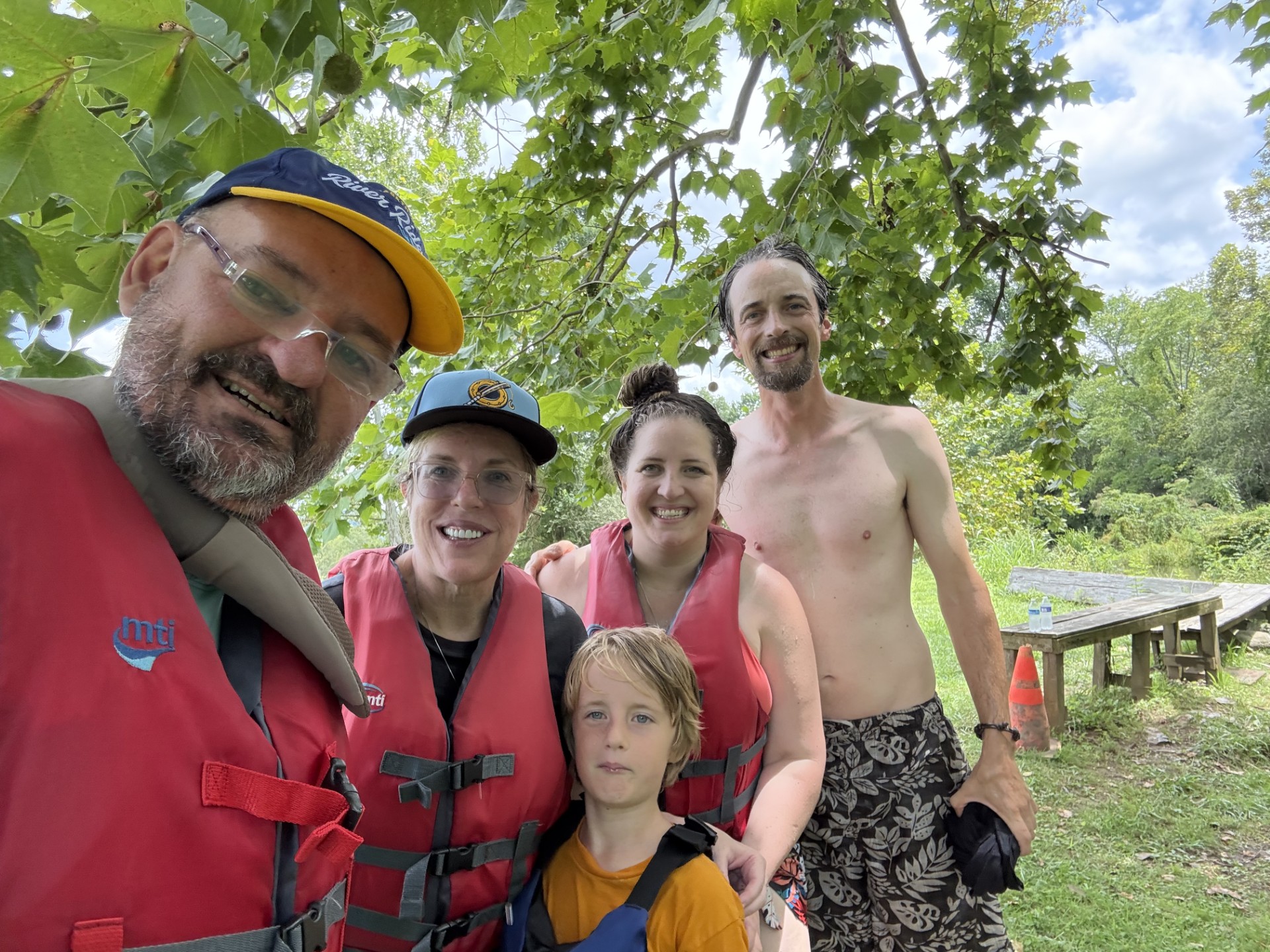 Family in PFDs side by side at the River House