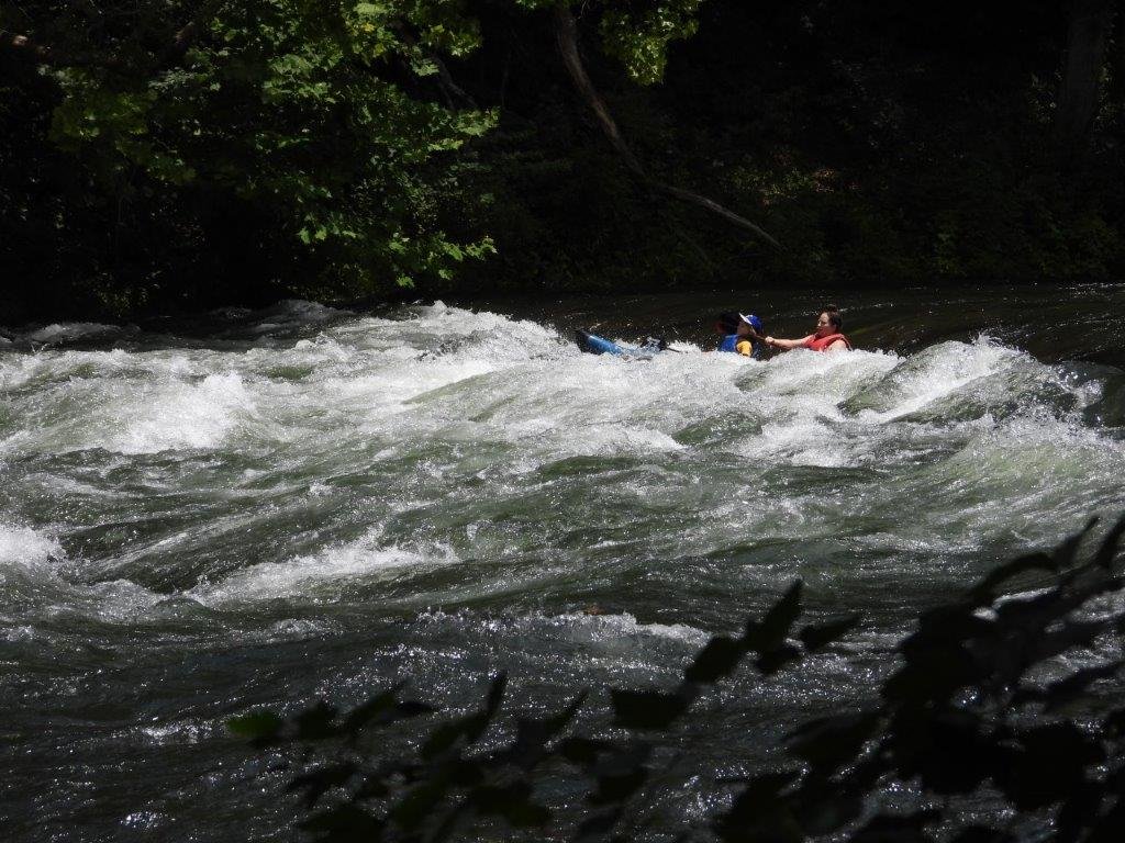 Tandem kayak hitting a wave train