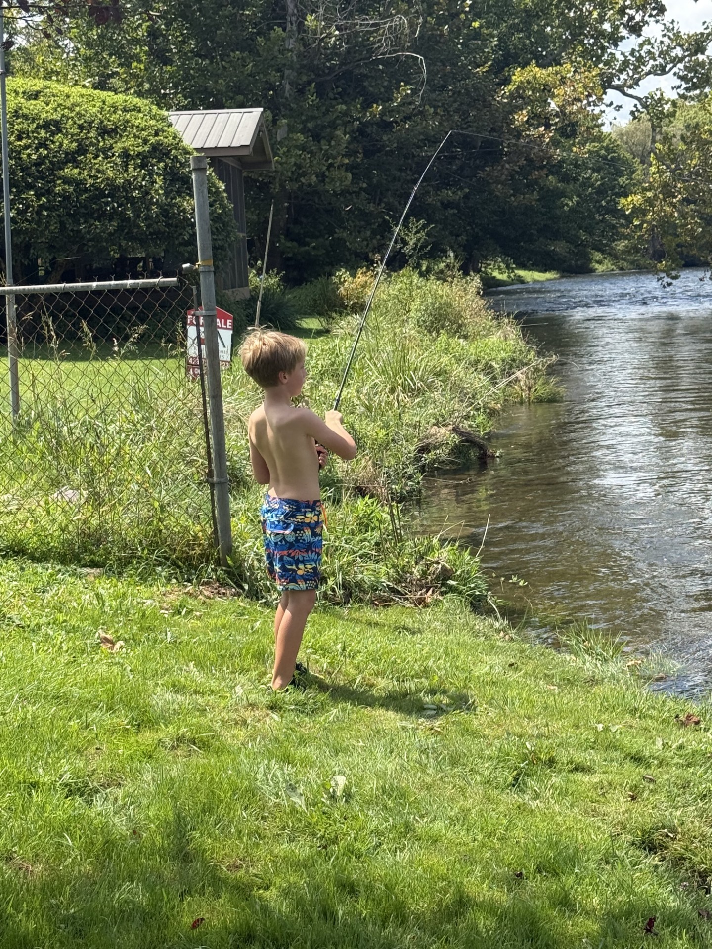 Boy fishing the bank at 1399 Broad